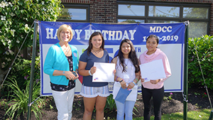  Barbara Beckett with three of her students whose art was selected as part of the MDCC at journal